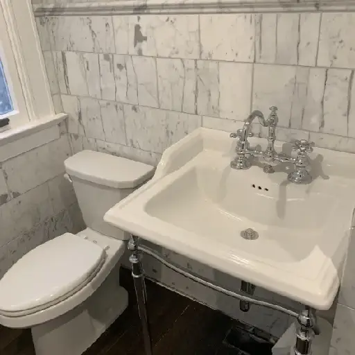 white bathroom with toilet seat & sink